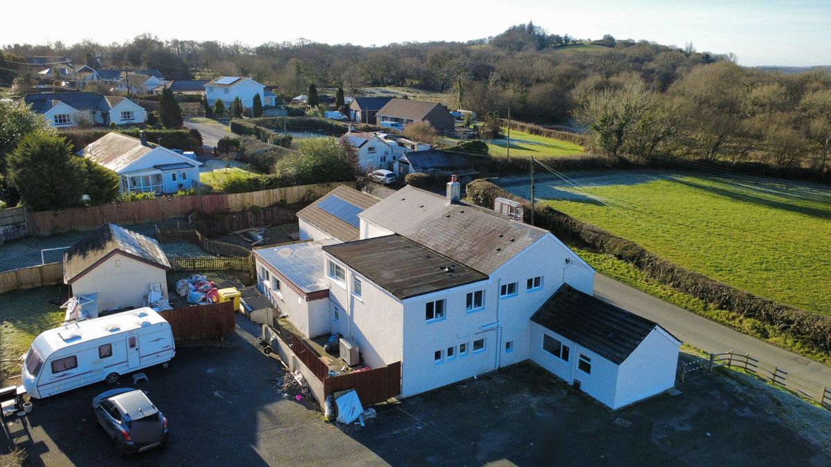 Aerial photo of a white house and outbuildings on a frosty morning in South Wales