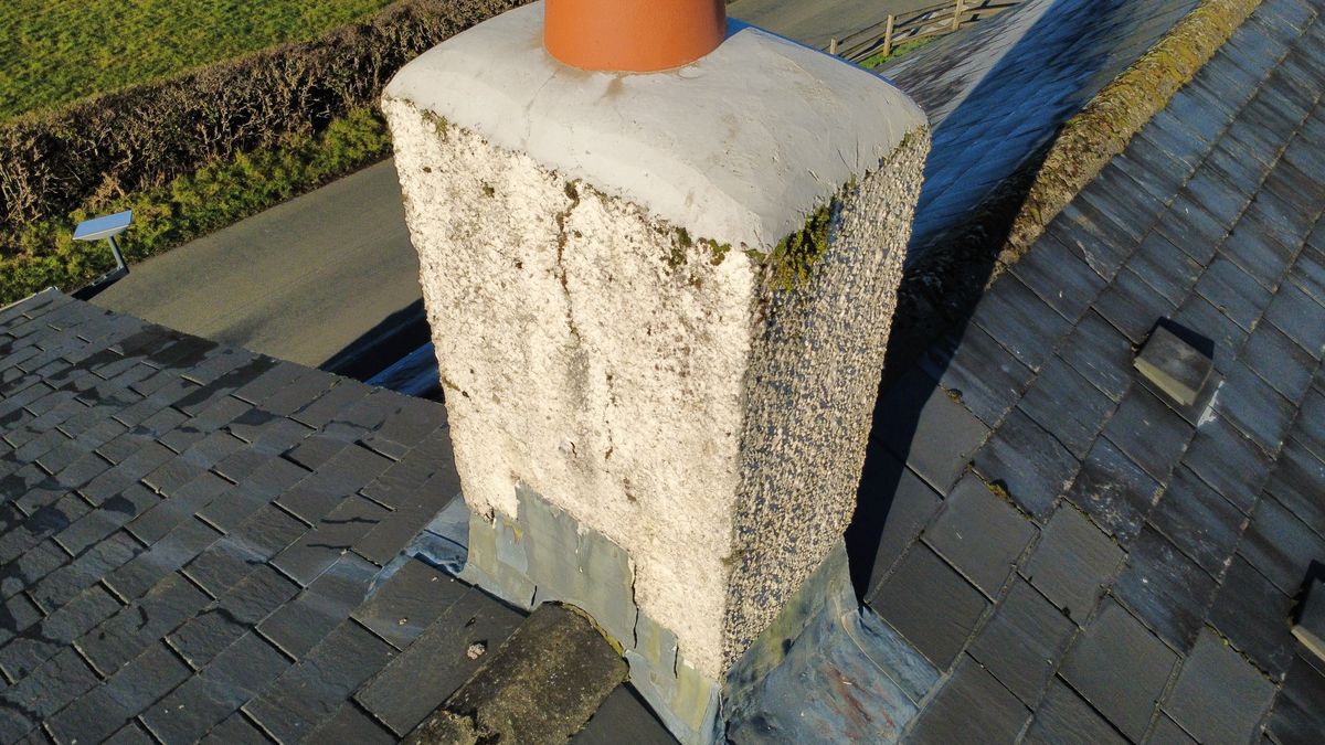 Drone photo of a chimney stack with a terracotta pot, taken from above
