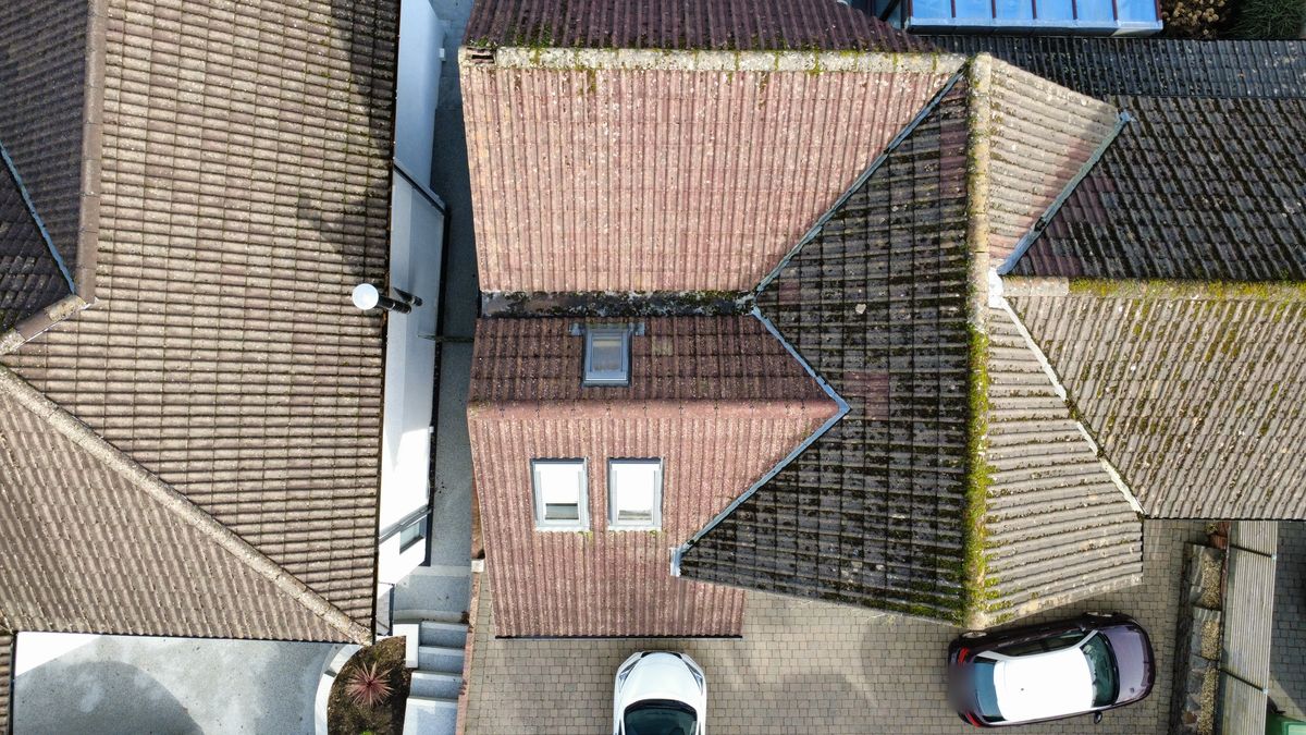 Top-down aerial photo of tiled roof valleys and dormer windows